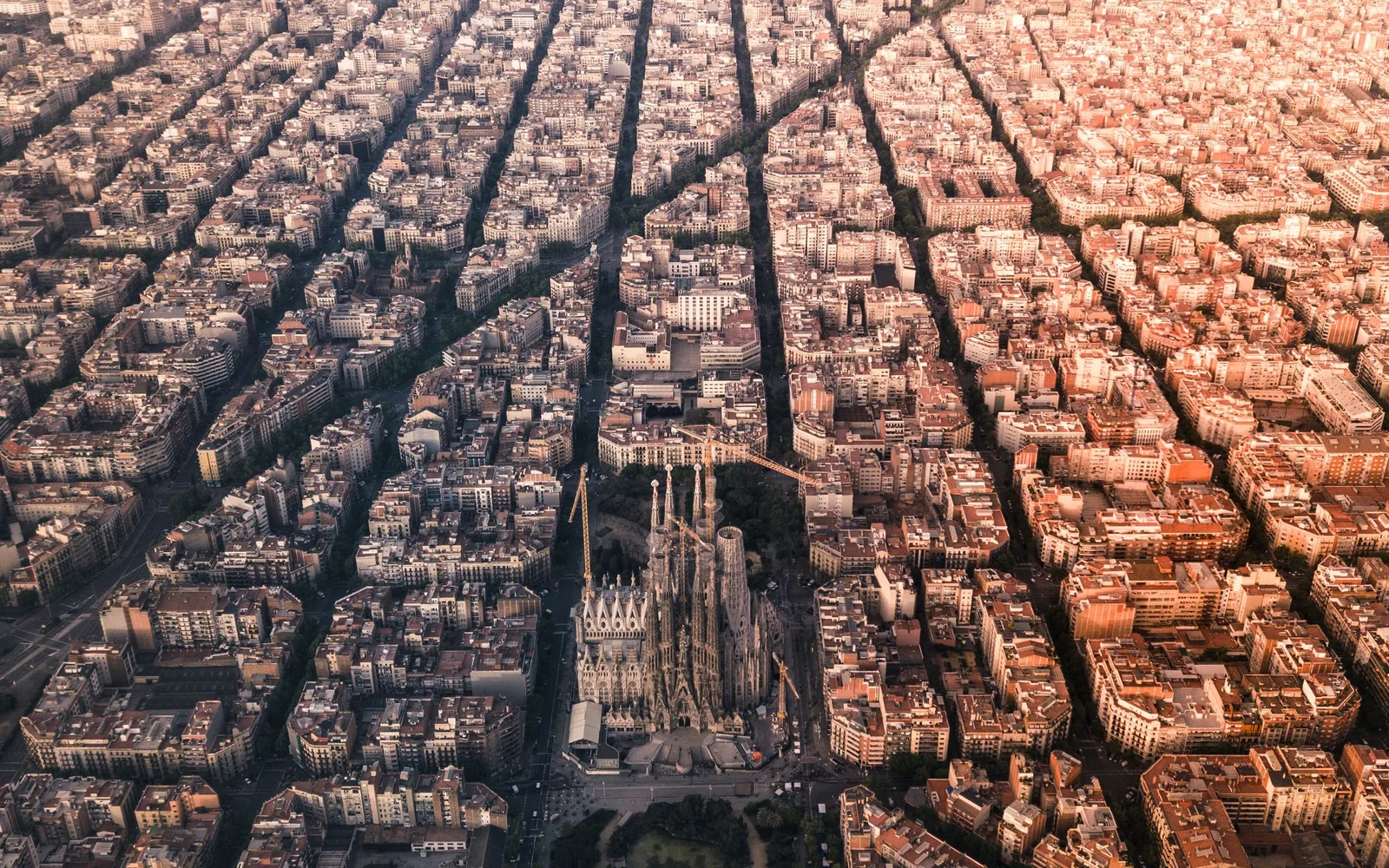 Aerial view of Barcelona’s Eixample blocks and the Sagrada Família.