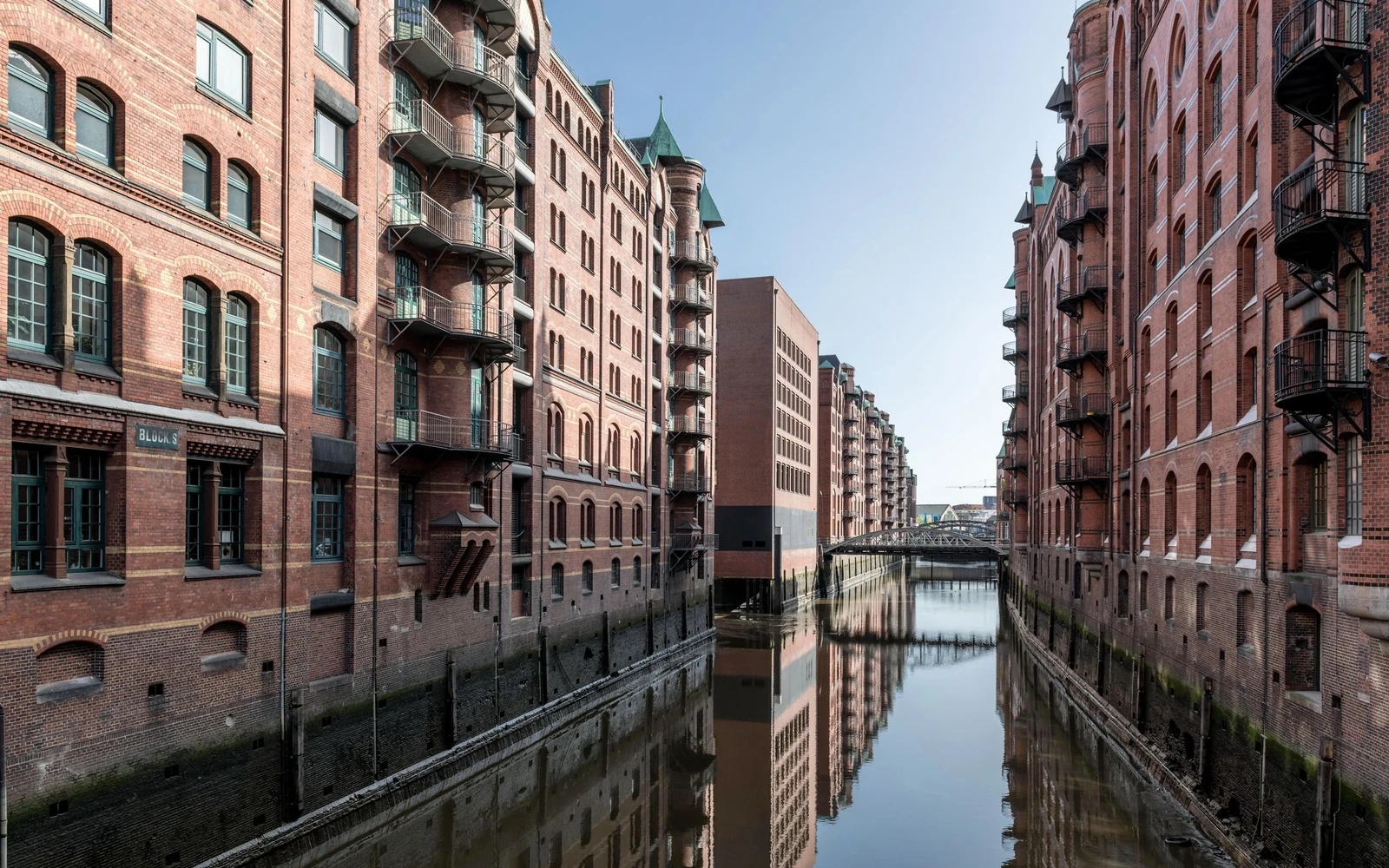 Brick warehouses reflected in a canal in Hamburg’s Speicherstadt.