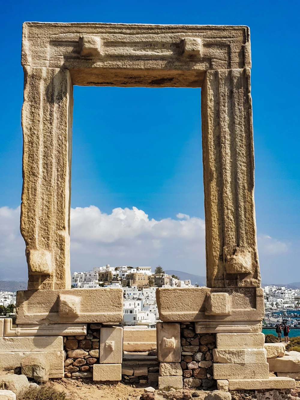 The marble Portara gateway framing buildings in Naxos Town.