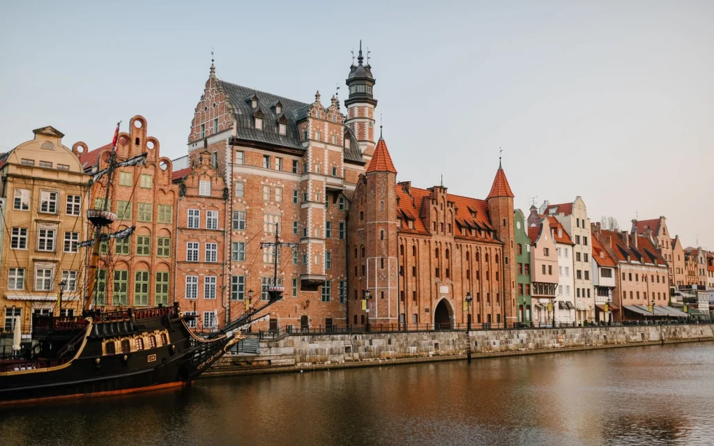 Historic buildings and boats along the Motława waterfront in Gdańsk, Poland.